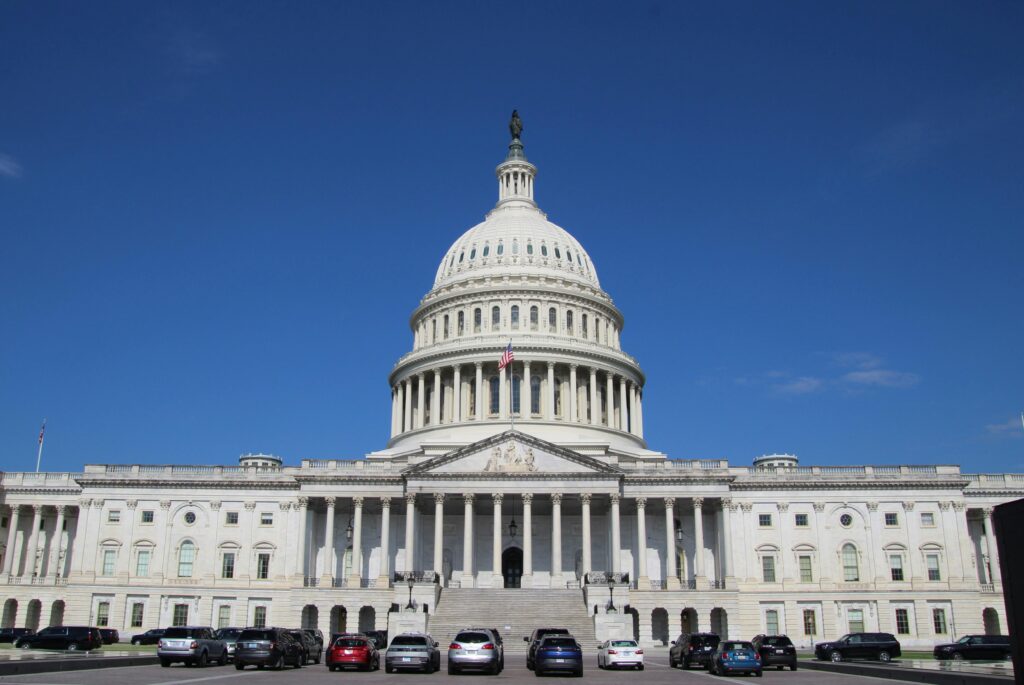 A striking image of the United States Capitol Building under a clear blue sky, symbolizing American democracy.